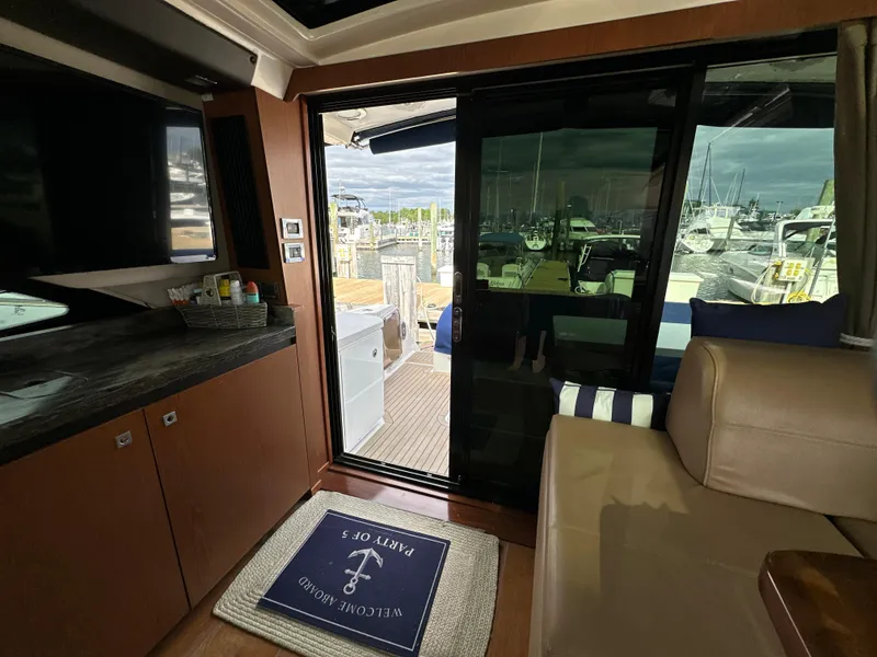 Slide: The Image of Interior view of 2014 Sea Ray 510 Sundancer yacht with sliding glass door to deck. - 24