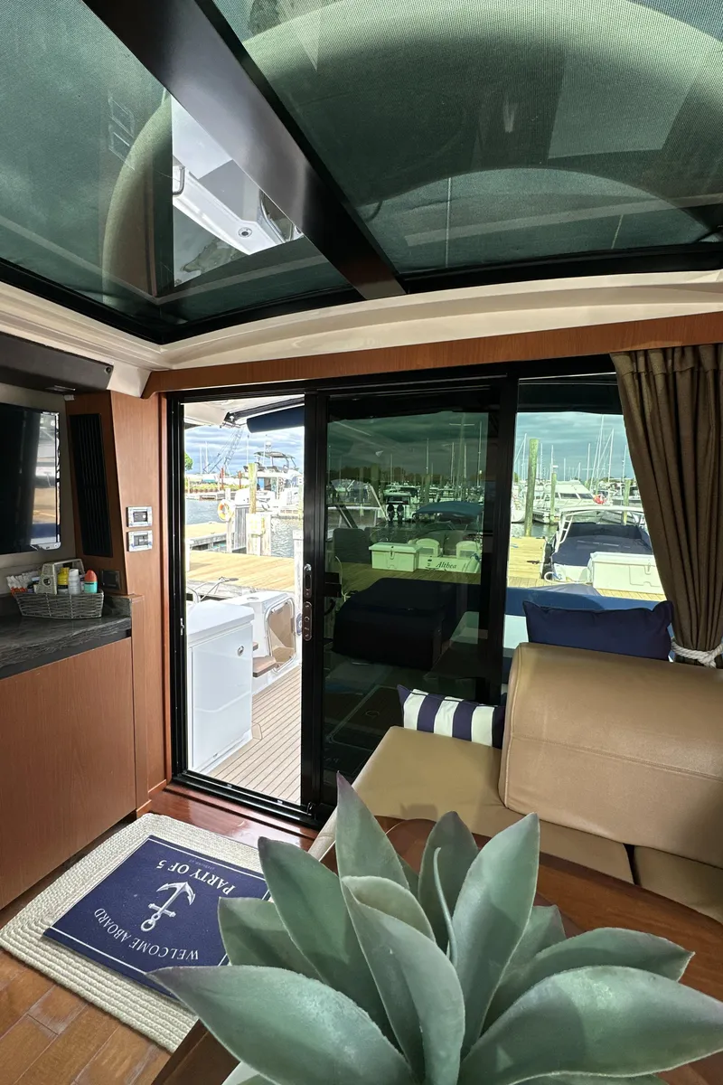 Slide: The Image of Interior view of 2014 Sea Ray 510 Sundancer yacht with glass ceiling and marina backdrop. - 25