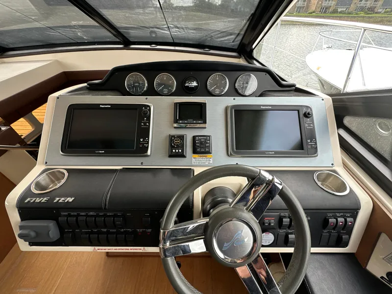Slide: The Image of Helm of 2014 Sea Ray 510 Sundancer with dual displays and steering wheel. - 26