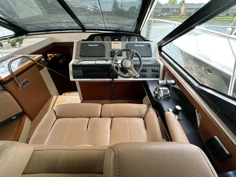 Slide: The Image of 2014 Sea Ray 510 Sundancer helm with leather seating and advanced navigation controls. - 28