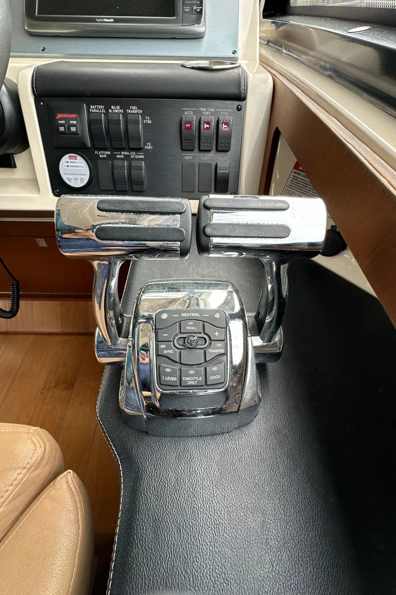 Slide: The Image of Control panel of a 2014 Sea Ray 510 Sundancer yacht, featuring throttle levers and switches. - 30