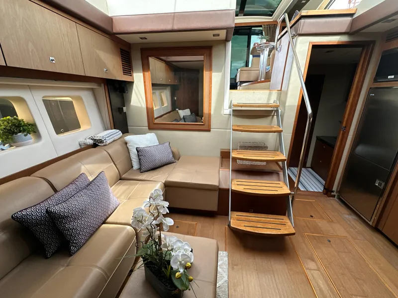 Slide: The Image of Luxurious interior of 2014 Sea Ray 510 Sundancer yacht with modern seating and wooden staircase. - 39