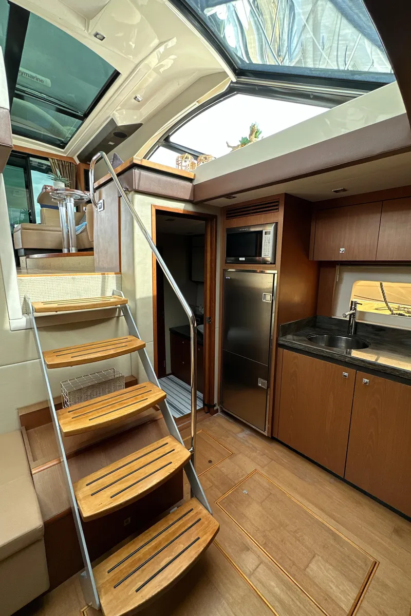 Slide: The Image of Interior of 2014 Sea Ray 510 Sundancer yacht with wooden stairs and modern kitchen. - 42