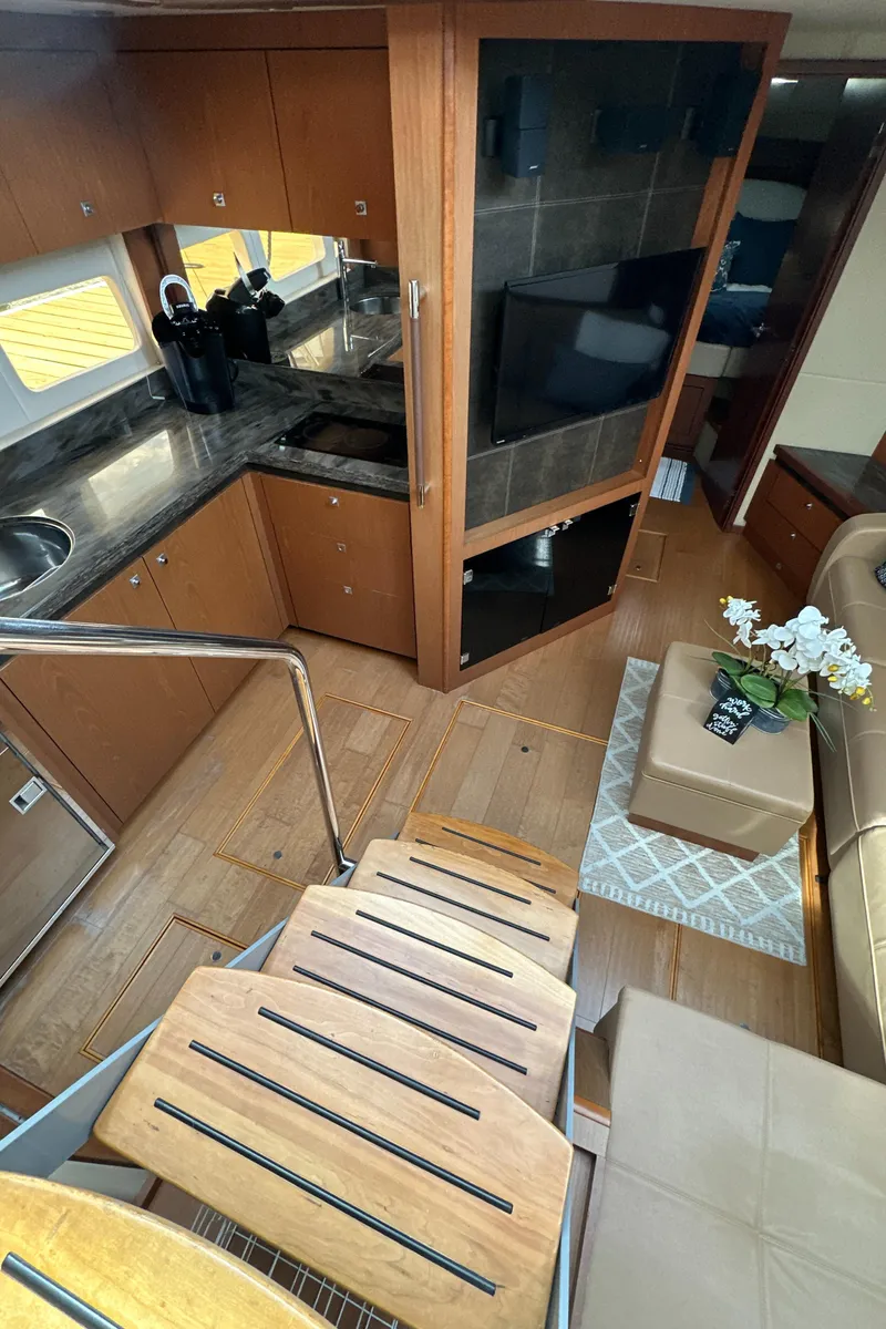 Slide: The Image of Interior of 2014 Sea Ray 510 Sundancer yacht with modern kitchen and cozy seating area. - 43