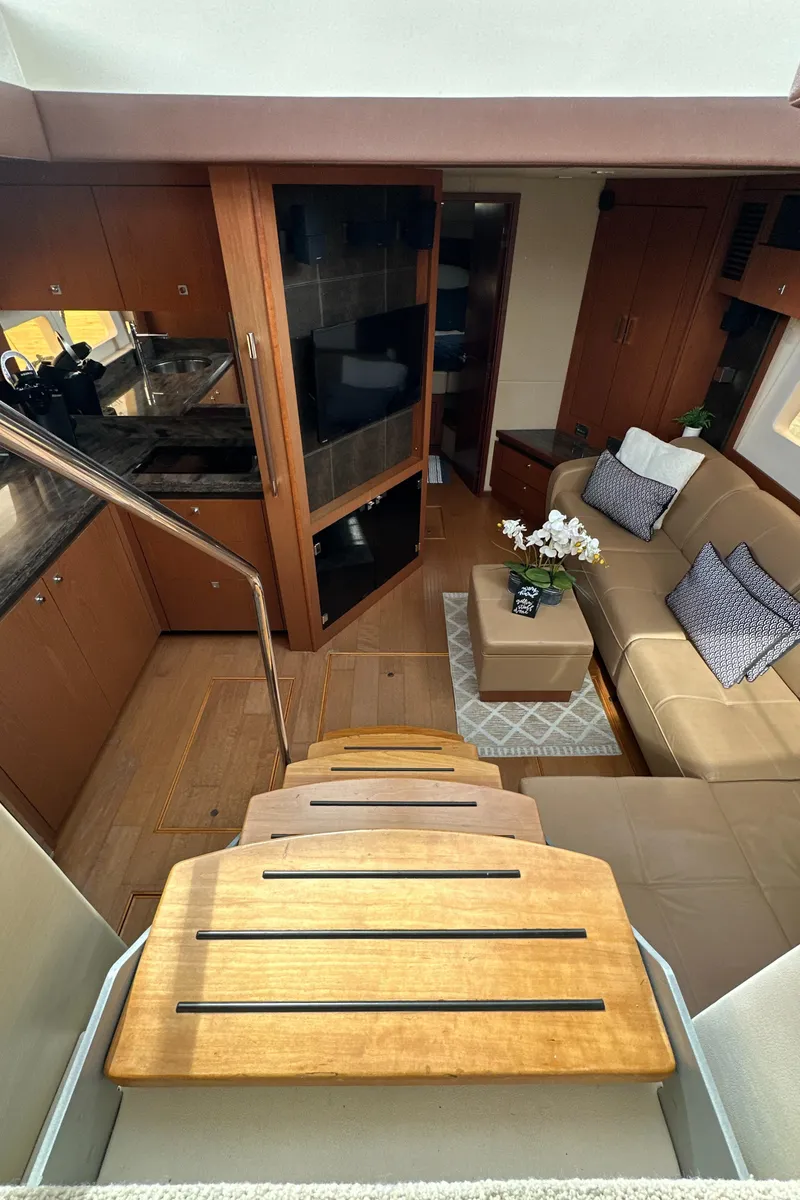 Slide: The Image of Interior of 2014 Sea Ray 510 Sundancer yacht with modern kitchen and cozy seating area. - 45
