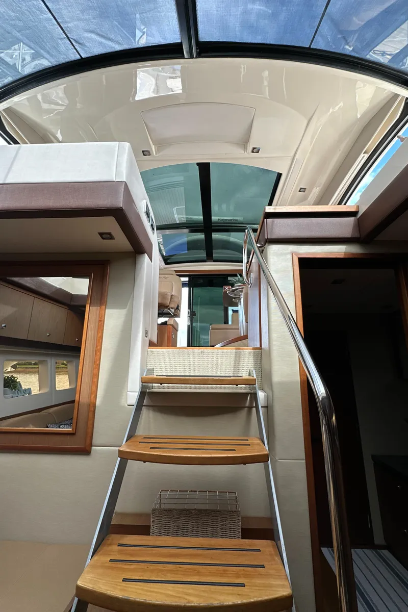 Slide: The Image of Interior view of 2014 Sea Ray 510 Sundancer yacht with wooden stairs and glass ceiling. - 47