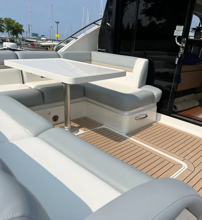 Slide: The Image of 2014 Sea Ray 510 Sundancer yacht with elegant outdoor seating and table on teak deck. - 6