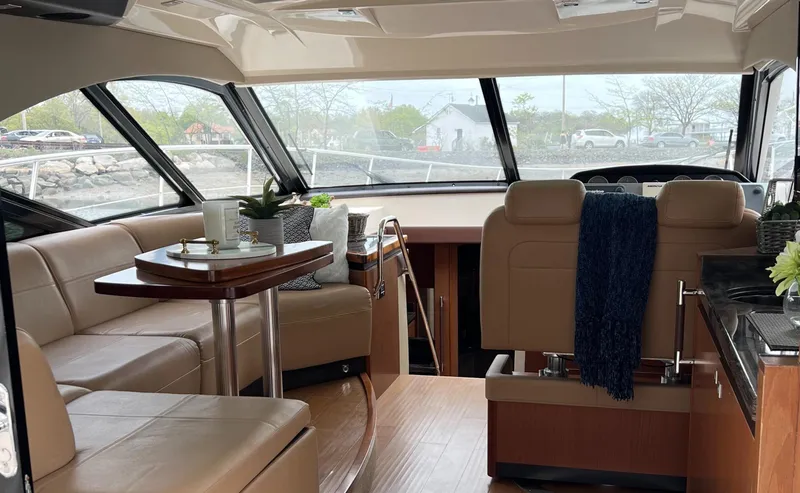 Slide: The Image of Luxurious interior of a 2014 Sea Ray 510 Sundancer yacht with elegant seating and dining area. - 8