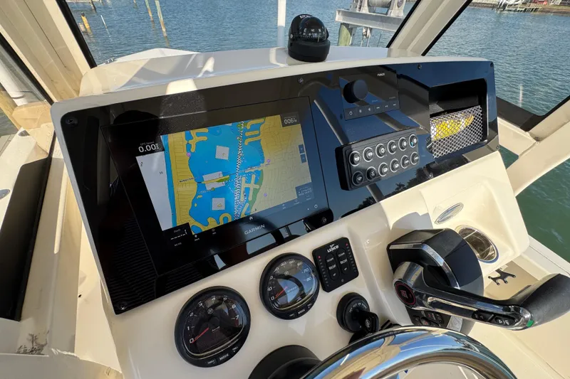 Slide: The Image of 2024 Scout 231 XSB boat dashboard with navigation system and controls. - 14