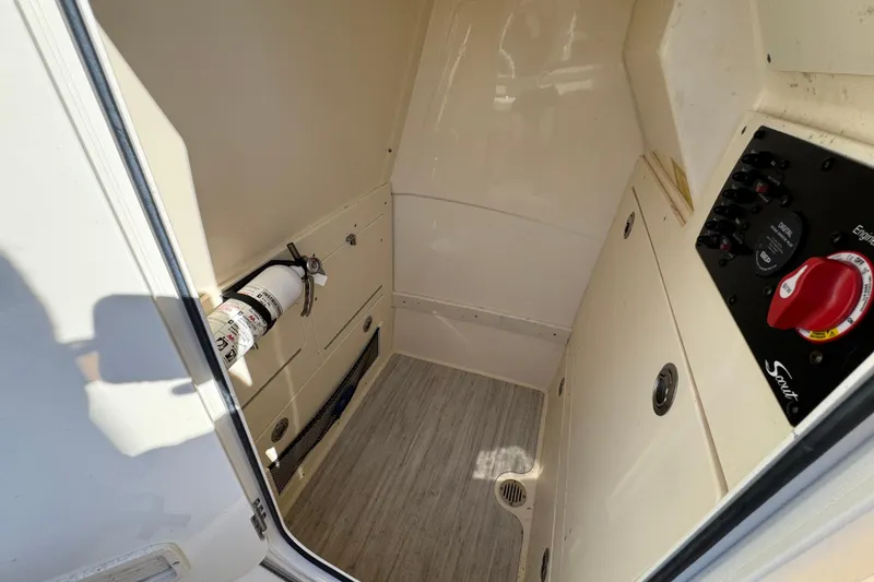 Slide: The Image of 2024 Scout 231 XSB boat interior with fire extinguisher and control panel. - 22