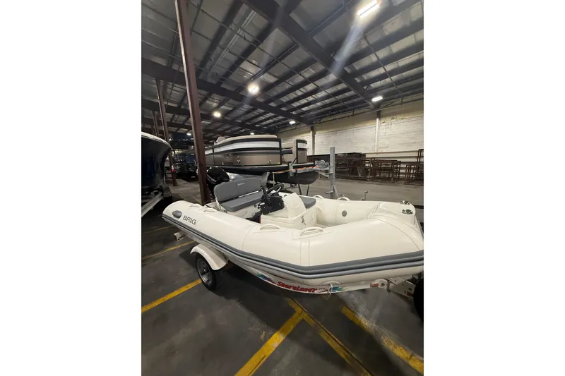 Slide: The Image of 2026 Brig Falcon 330 inflatable boat in a warehouse setting. - 12