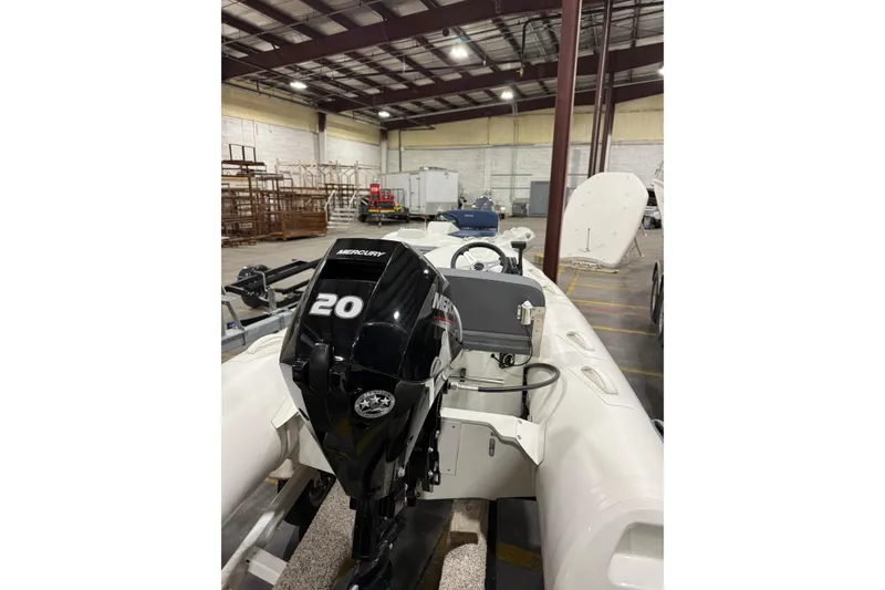 Slide: The Image of 2026 Brig Falcon 330 inflatable boat with Mercury 20 outboard motor in warehouse. - 9