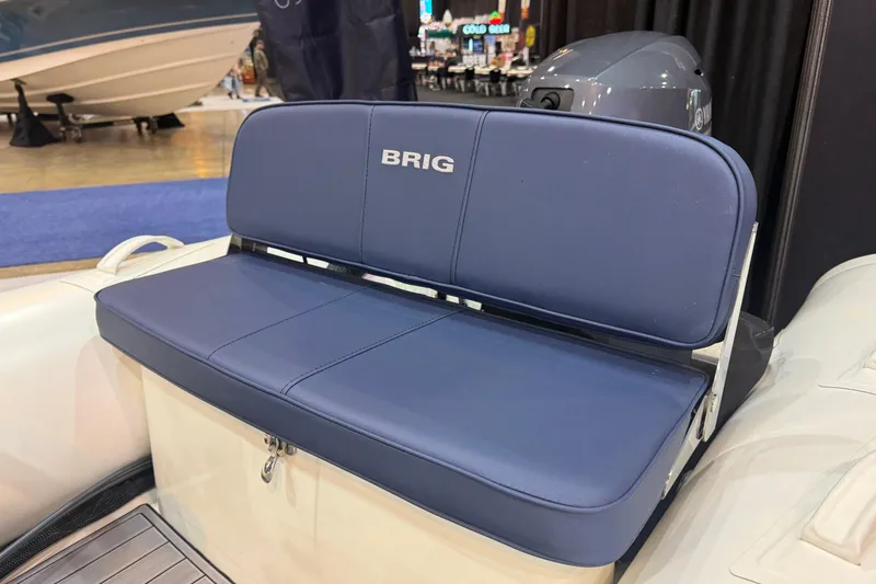 Slide: The Image of 2026 Brig Falcon 330 boat seat with blue upholstery and storage compartment. - 13