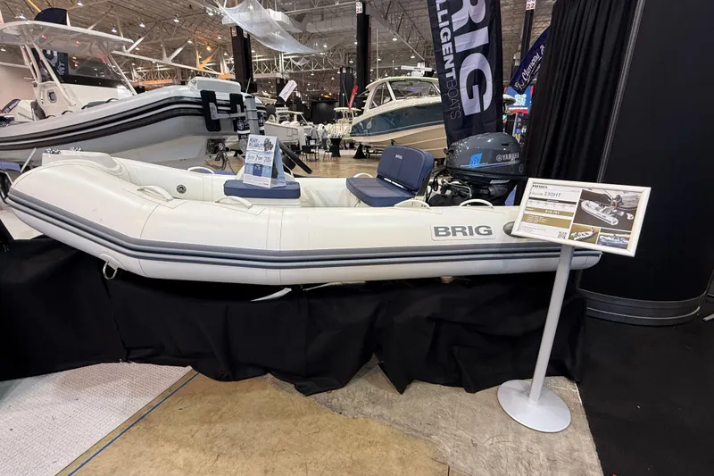 Slide: The Image of 2026 Brig Falcon 330 inflatable boat displayed at a boat show. - 16