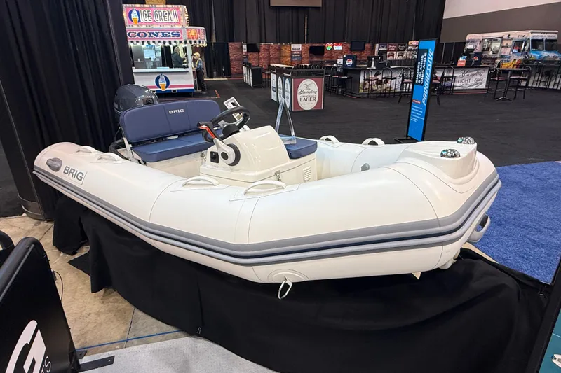 The Image of 2026 Brig Falcon 330 inflatable boat displayed indoors at a marine exhibition. - 9