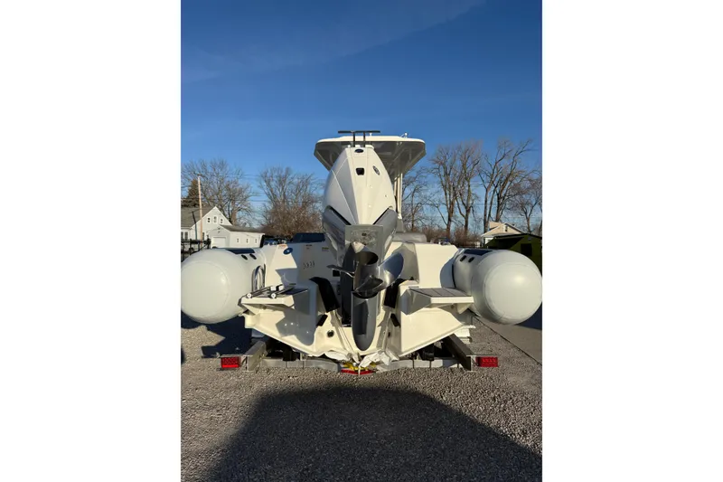 Slide: The Image of 2026 Brig Eagle 8 boat on trailer, rear view, under clear blue sky. - 10