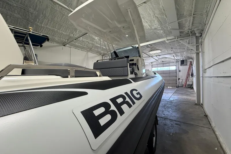 Slide: The Image of 2026 Brig Eagle 8 boat in a garage, showcasing sleek design and branding. - 11