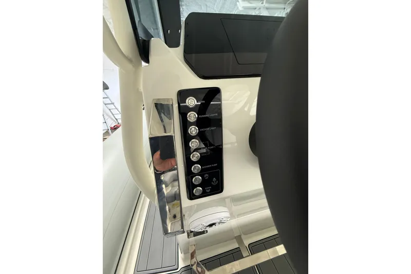 Slide: The Image of Control panel of 2026 Brig Eagle 8 boat, featuring various switches and buttons. - 15