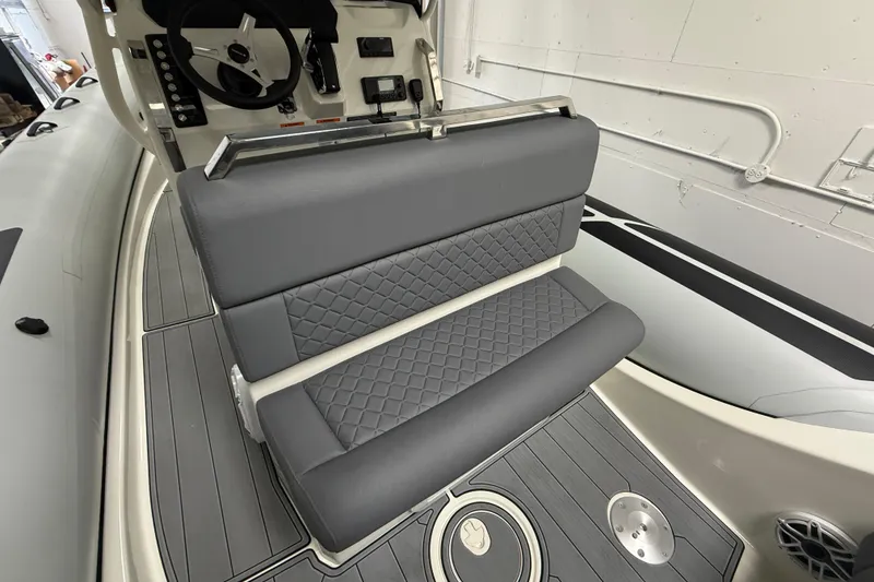 Slide: The Image of 2026 Brig Eagle 8 boat interior with gray quilted seating and modern dashboard. - 18