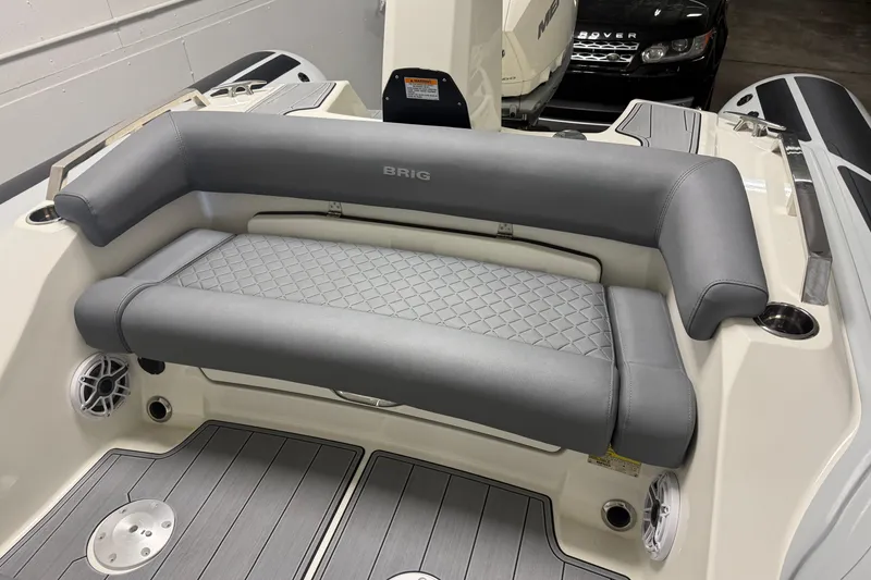 Slide: The Image of 2026 Brig Eagle 8 boat interior with gray cushioned seating and modern design. - 19