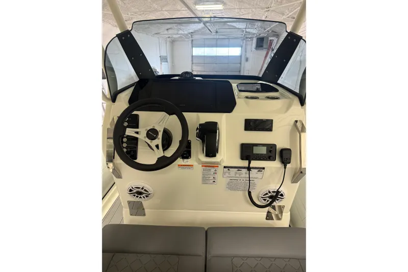 Slide: The Image of 2026 Brig Eagle 8 boat dashboard with steering wheel and control panel. - 23