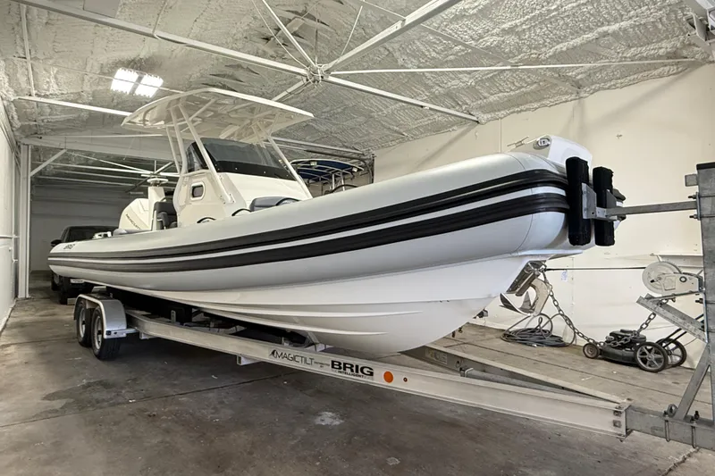 The Image of 2026 Brig Eagle 8 boat on trailer in indoor storage facility. - 8