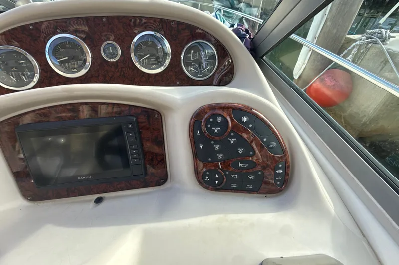 Slide: The Image of Control panel of a 2002 Sea Ray 320 Sundancer boat with gauges and Garmin display. - 10