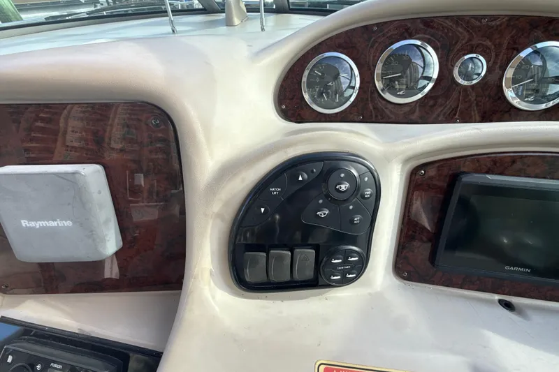Slide: The Image of Control panel of a 2002 Sea Ray 320 Sundancer with Raymarine and Garmin displays. - 11