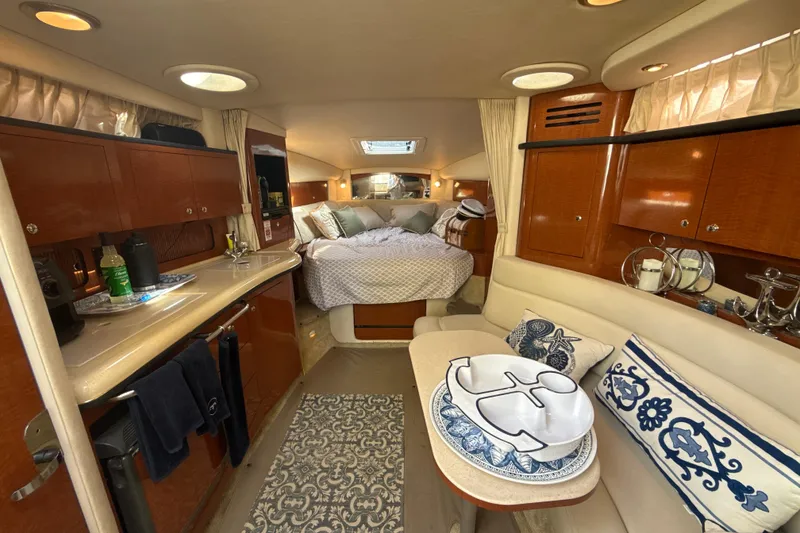 Slide: The Image of Luxurious interior of a 2002 Sea Ray 320 Sundancer yacht with cozy cabin and elegant decor. - 18