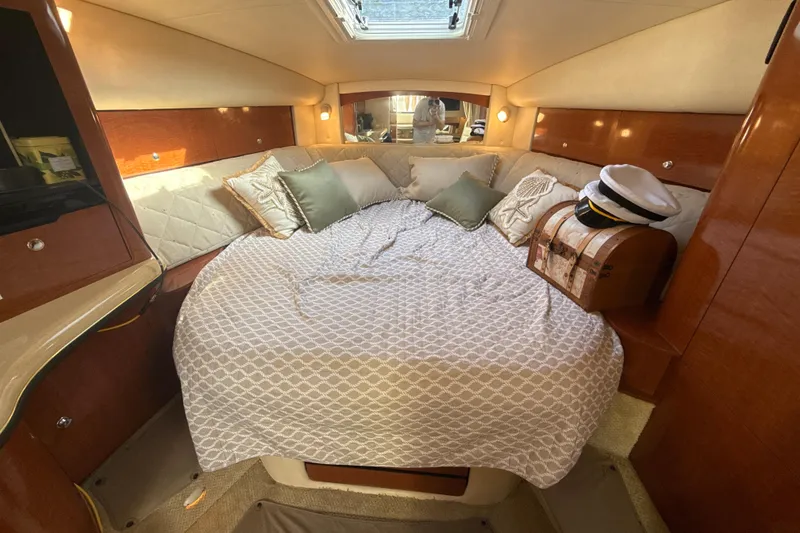 Slide: The Image of Cozy cabin interior of 2002 Sea Ray 320 Sundancer with bed and nautical decor. - 21