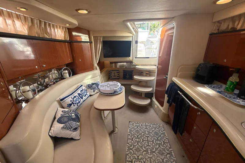 Slide: The Image of Luxurious interior of a 2002 Sea Ray 320 Sundancer yacht with elegant seating and decor. - 22