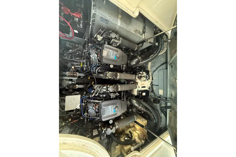 Slide: The Image of Engine compartment of a 2002 Sea Ray 320 Sundancer boat, showcasing dual engines. - 26