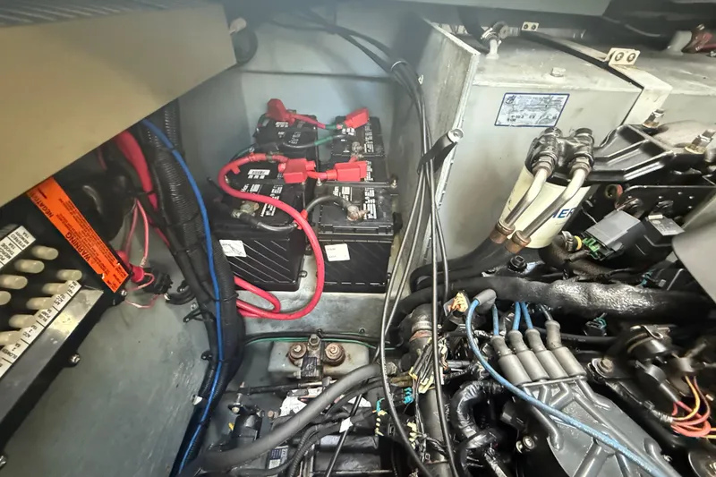 Slide: The Image of Engine compartment of a 2002 Sea Ray 320 Sundancer with batteries and wiring. - 28