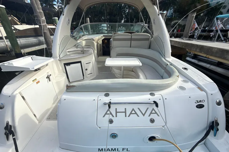 Slide: The Image of 2002 Sea Ray 320 Sundancer boat interior with seating and table, docked in Miami, FL. - 3