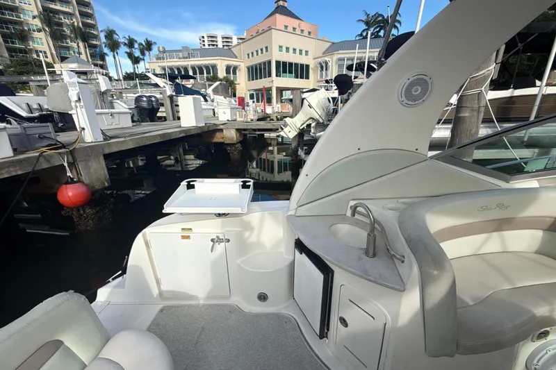 Slide: The Image of 2002 Sea Ray 320 Sundancer interior with sink and seating at marina. - 6
