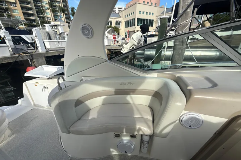 Slide: The Image of 2002 Sea Ray 320 Sundancer boat interior with seating and marina view. - 8
