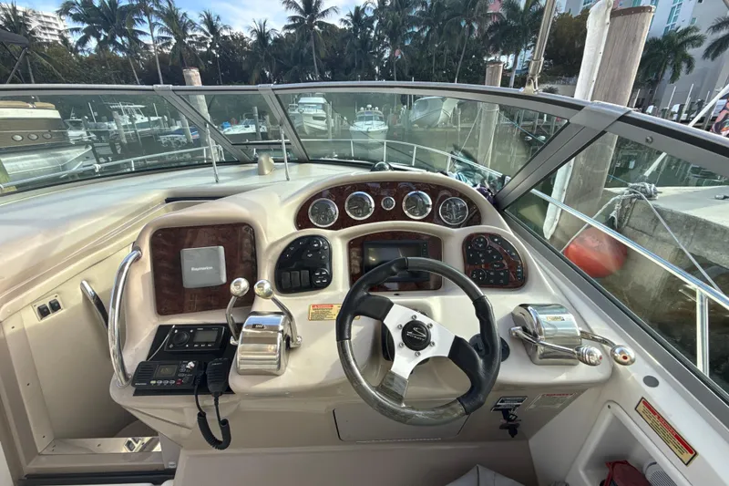Slide: The Image of Cockpit of 2002 Sea Ray 320 Sundancer with steering wheel and control panel. - 9
