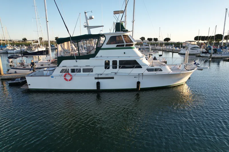 The Image of 1966 Drake 53 yacht docked in a marina, surrounded by other boats. - 0