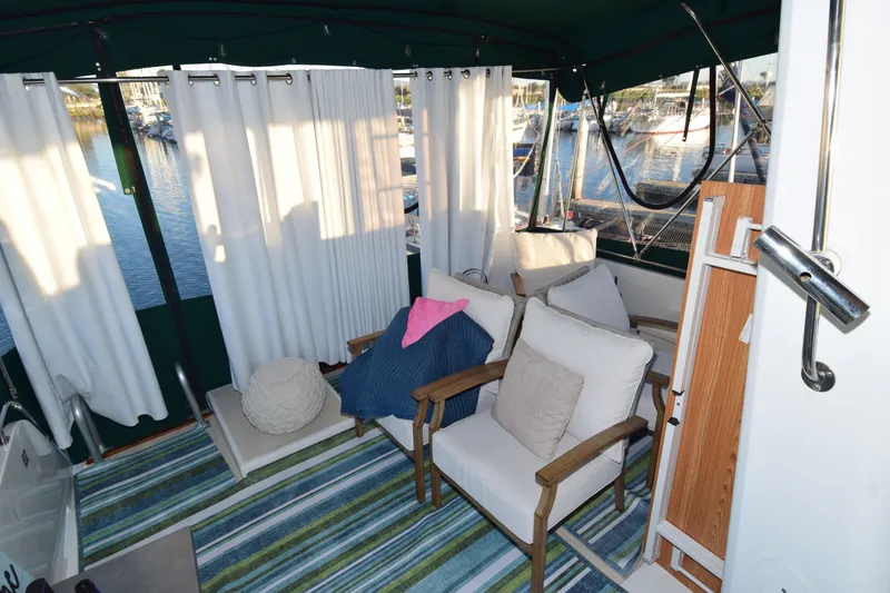 Slide: The Image of Cozy interior of 1966 Drake 53 boat with seating, cushions, and striped rug. - 10