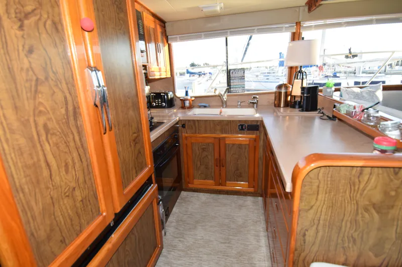 Slide: The Image of Vintage 1966 Drake 53 yacht kitchen with wood cabinetry and modern appliances. - 11