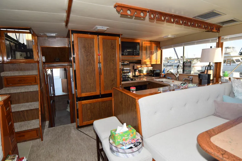 Slide: The Image of Interior of a 1966 Drake 53 yacht with wood cabinetry and cozy seating area. - 12