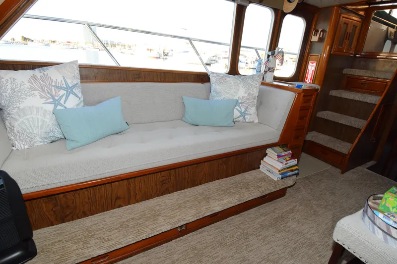 Slide: The Image of Interior of 1966 Drake 53 yacht with cozy seating and nautical-themed pillows. - 15