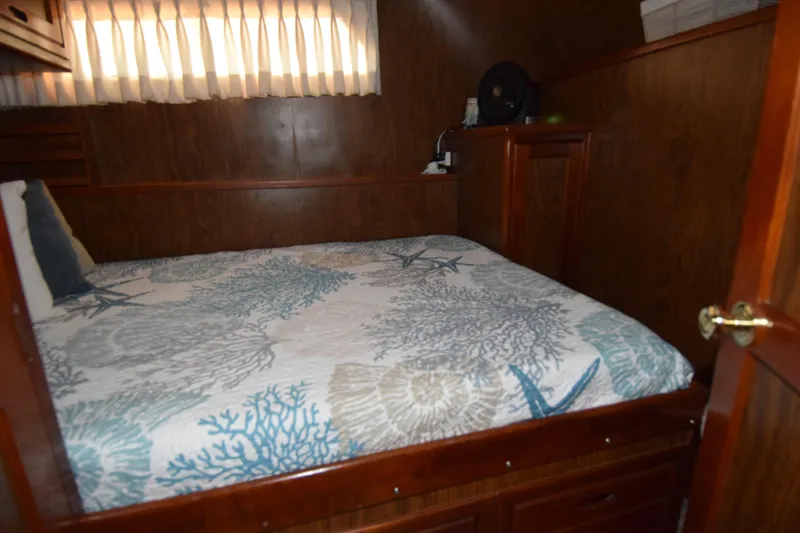 Slide: The Image of Cozy cabin bedroom in 1966 Drake 53 boat with nautical-themed bedding. - 16