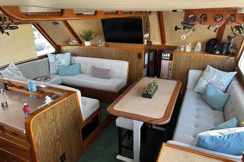 Slide: The Image of Cozy interior of a 1966 Drake 53 boat with plush seating and wooden accents. - 26