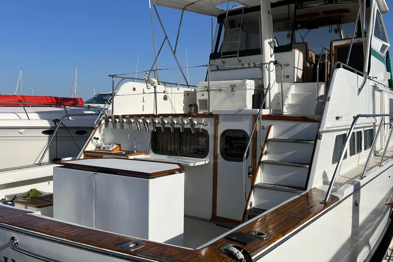 Slide: The Image of 1966 Drake 53 yacht with wooden deck, docked in a marina under clear blue skies. - 28