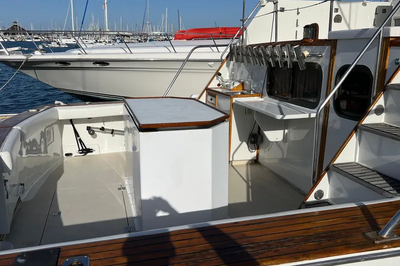 Slide: The Image of 1966 Drake 53 yacht deck with fishing rod holders, docked at marina. - 29