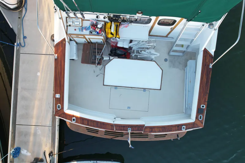 Slide: The Image of Aerial view of 1966 Drake 53 boat deck with green canopy and wooden trim. - 3