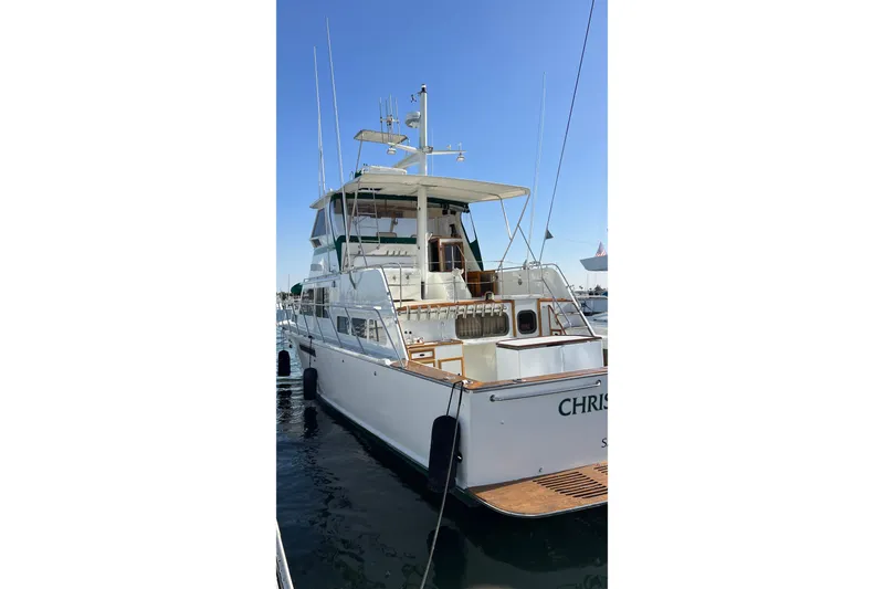 Slide: The Image of 1966 Drake 53 yacht docked at marina, rear view with clear sky. - 30