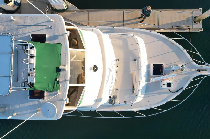 Slide: The Image of Aerial view of 1966 Drake 53 yacht docked, featuring green canopy and spacious deck. - 4