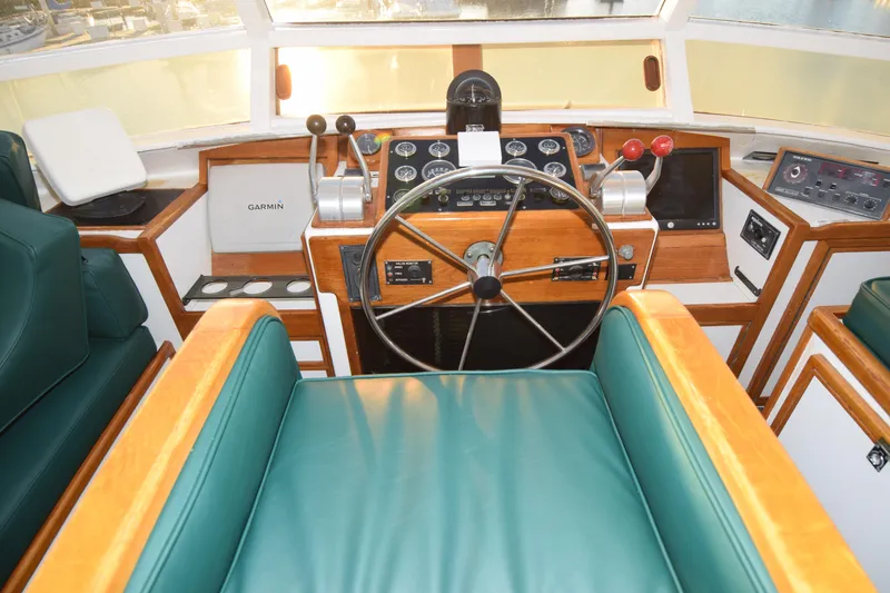 Slide: The Image of 1966 Drake 53 boat cockpit with vintage steering wheel and navigation controls. - 5